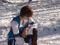 Photo of a GW2 Elementalist cosplay in Country armor, kneeling in the snow.