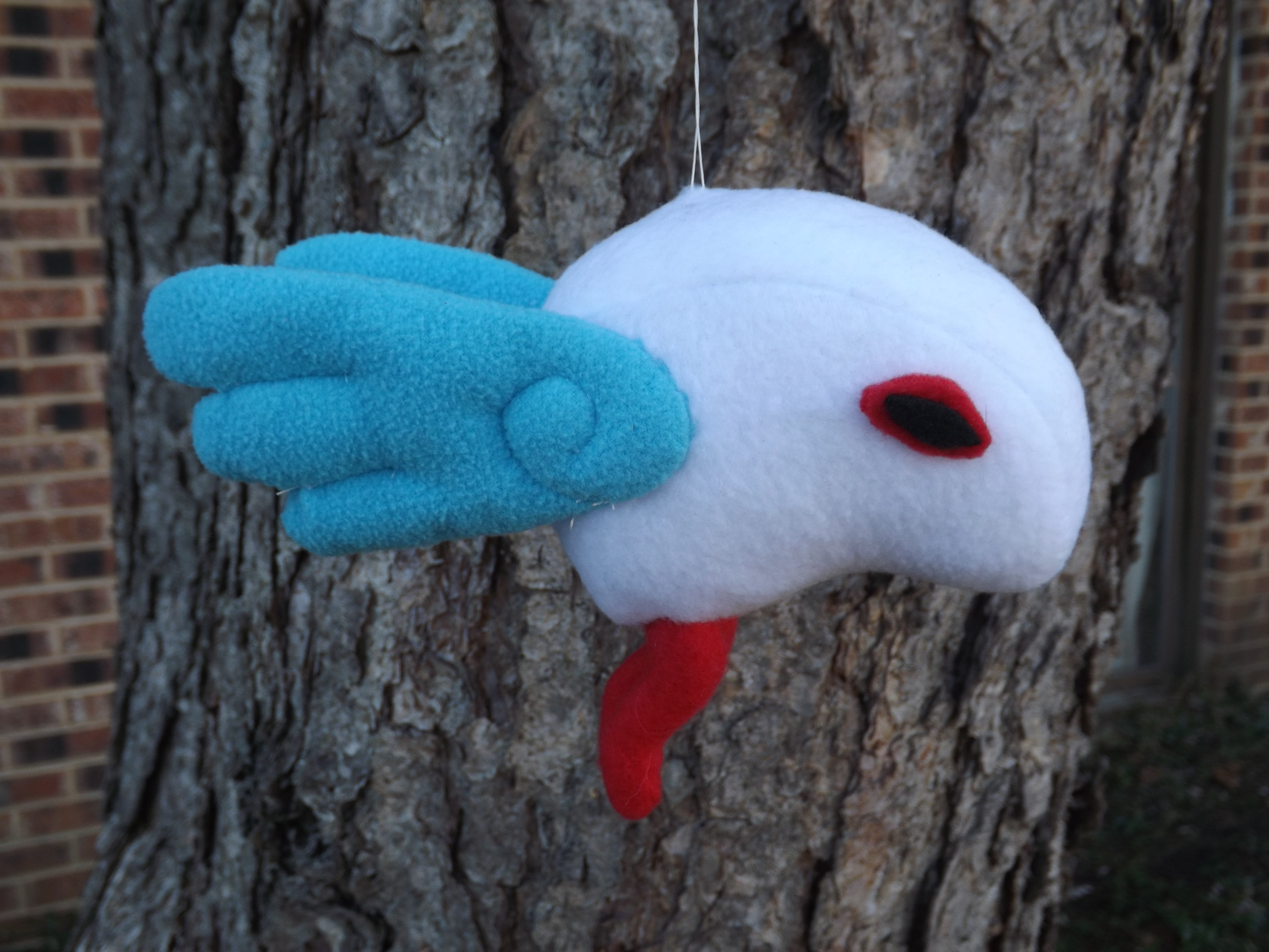 A photo of the finished Sheerow plush from the side.