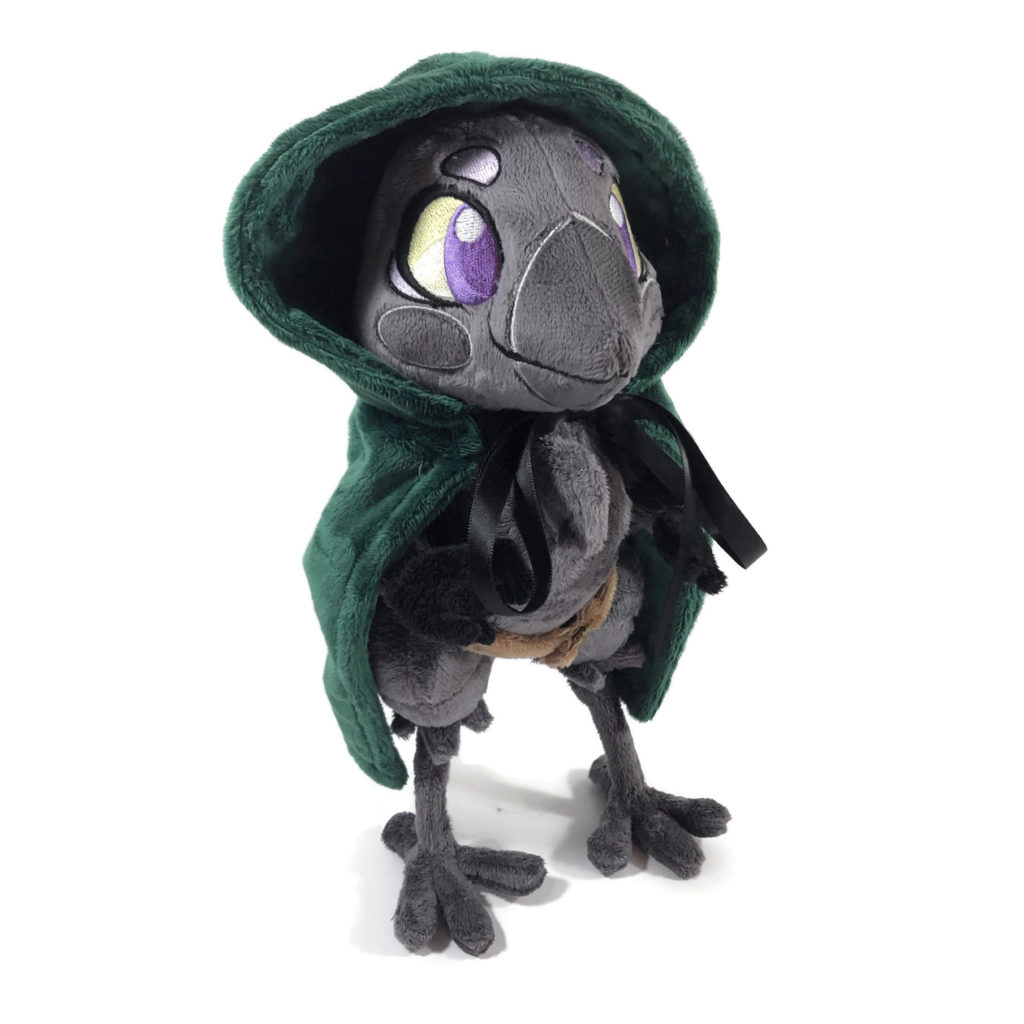 plush gray anthropomorphic crow with embroidered eyes and a green cloak